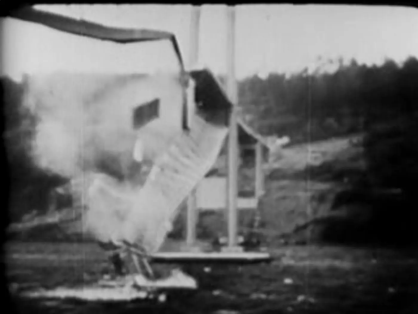 The deck of the Tacoma Narrows Bridge tearing apart and falling into the water